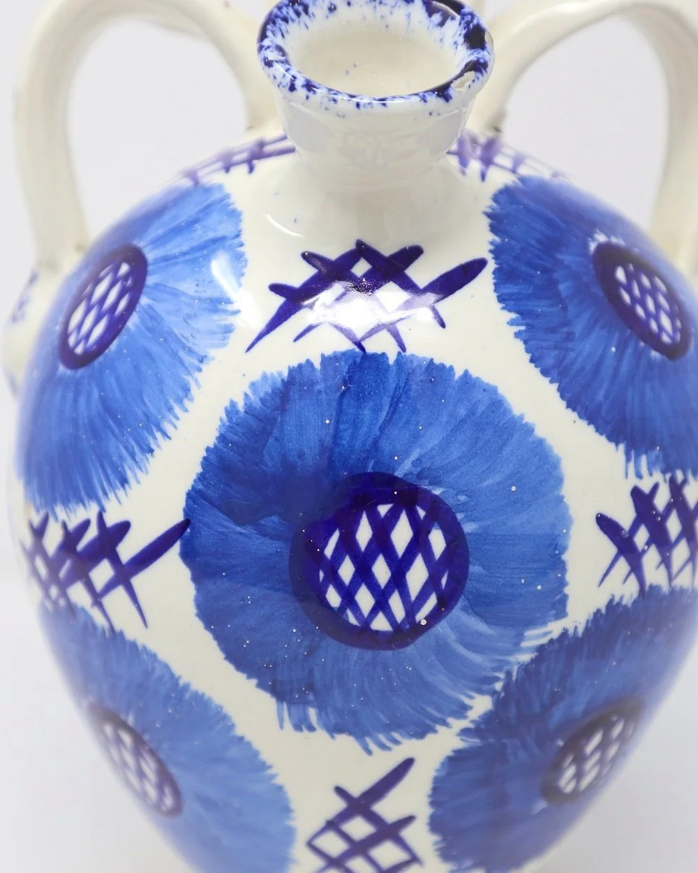 Blue and white Mediterranean style ceramic oil pourer with loop handles and hand painted floral details. Circa 1960s.