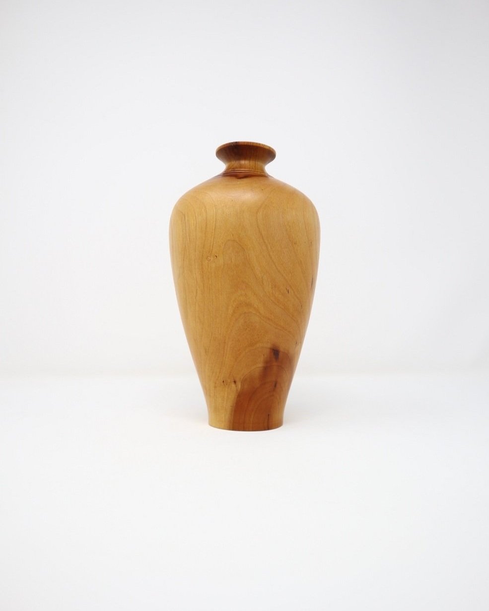 Small, lightweight turned wooden stem vase with three bands carved around the top.