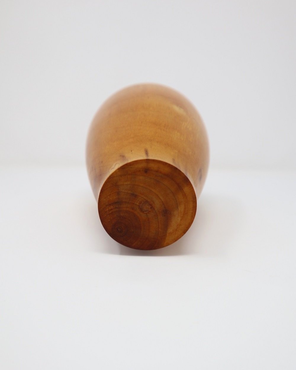 Small, lightweight turned wooden stem vase with three bands carved around the top.