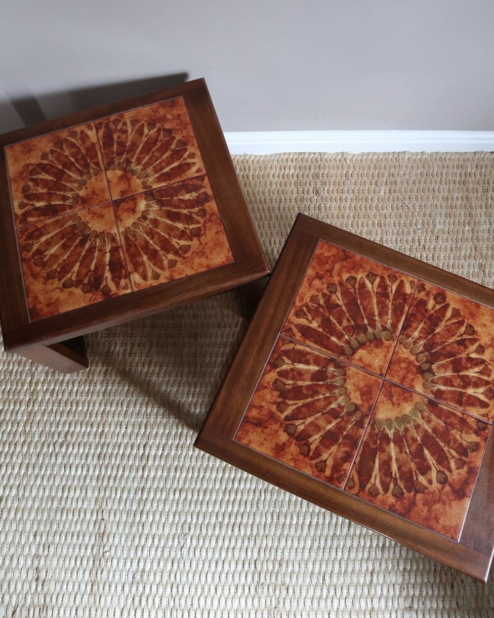 Pair of mid century 1970s Danish tile top 'Sunburst' teak side tables with sled legs.