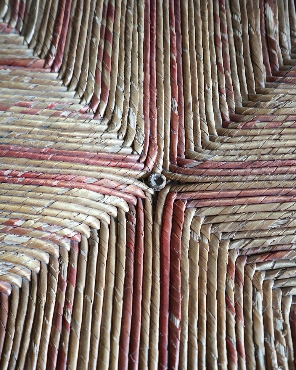 Characterful antique bobbin corner chair with interwoven red and natural rush seat and charming green and red velvet seat cushion. Circa 19th Century.