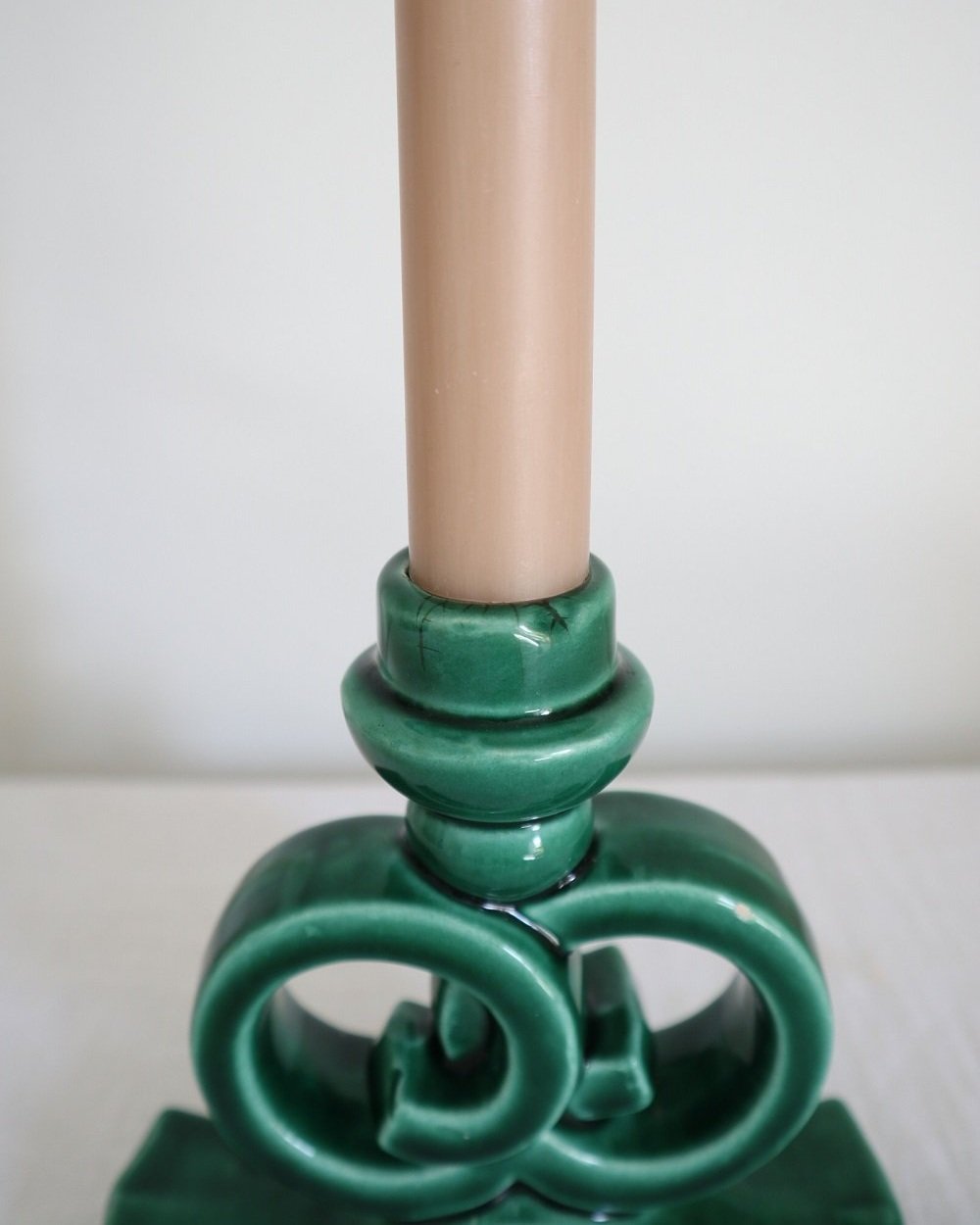 Striking jewel green glazed ceramic candleholder with intertwined circles. Similar to the designs from Vallauris, France.