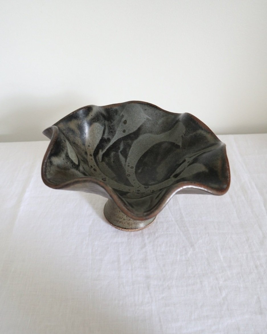 Vintage studio pottery pedestal bowl with wavy edge, deep blue, grey and grey glaze with an abstract design.