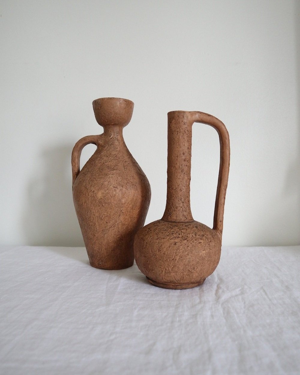 Pair of mid century sculptural textured brown ceramic vessels. Fragile terracotta with pock marked surface. Circa 1970s.