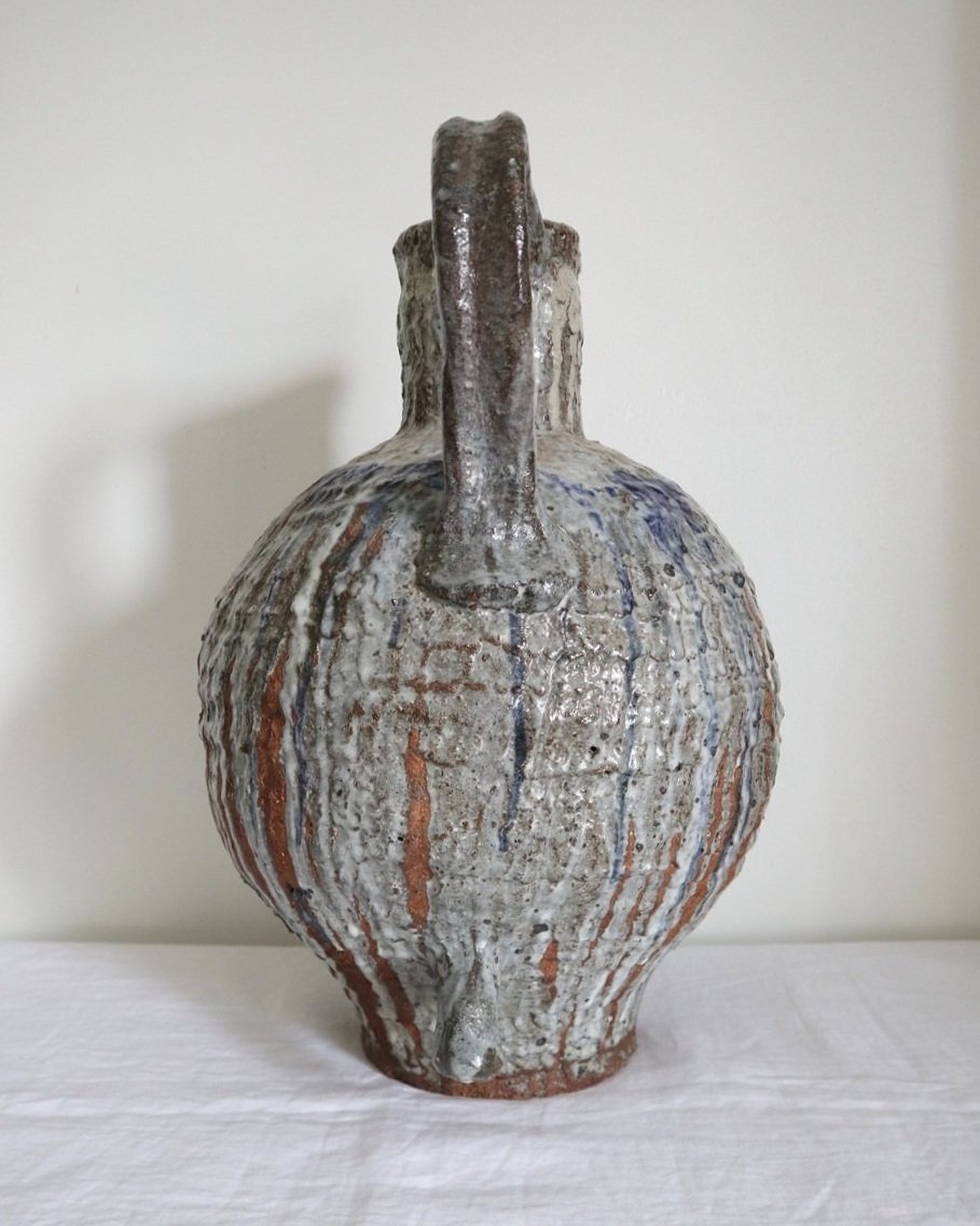 Very heavy textured blue grey drip glaze ceramic floor vase with loop handle.