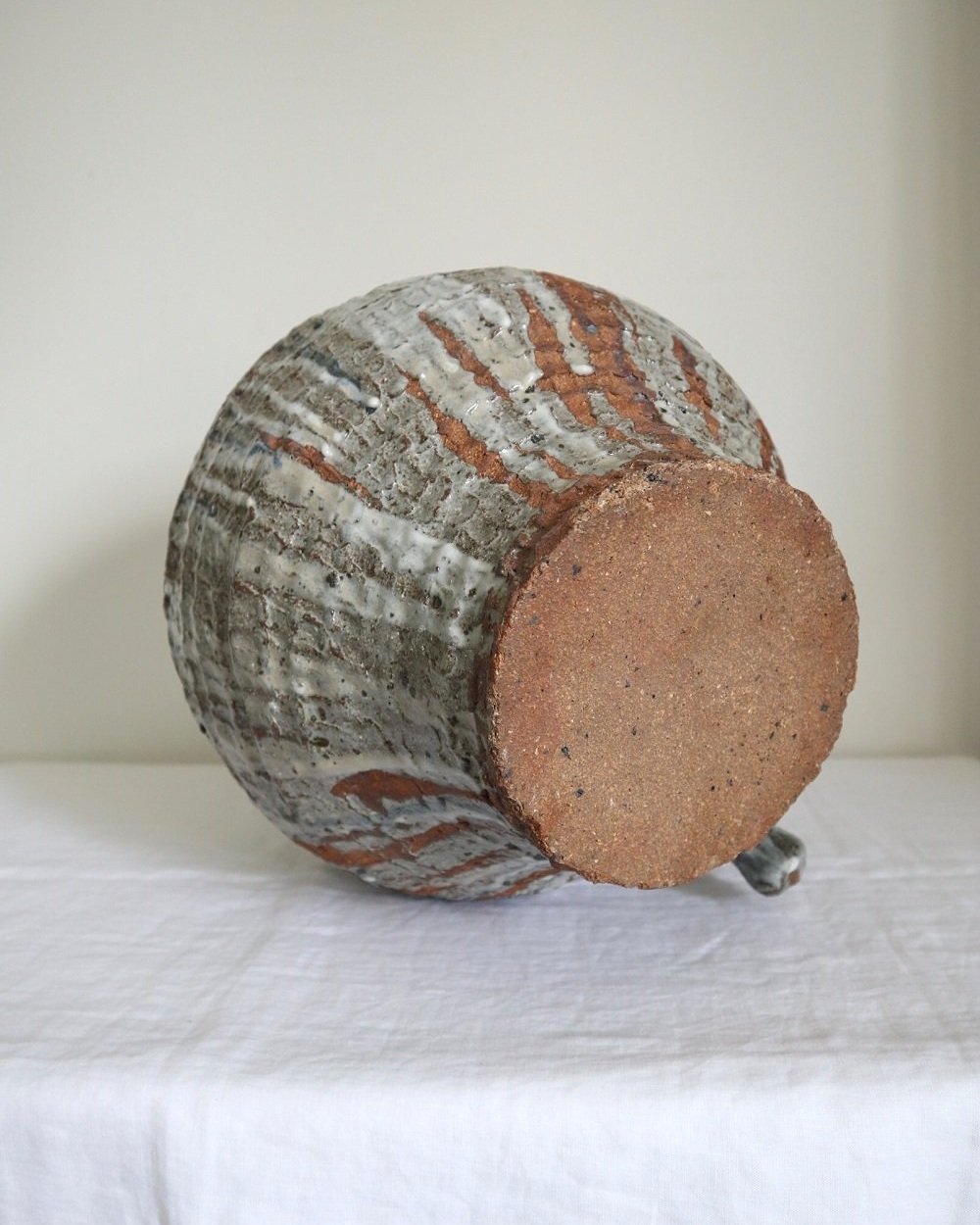 Very heavy textured blue grey drip glaze ceramic floor vase with loop handle.
