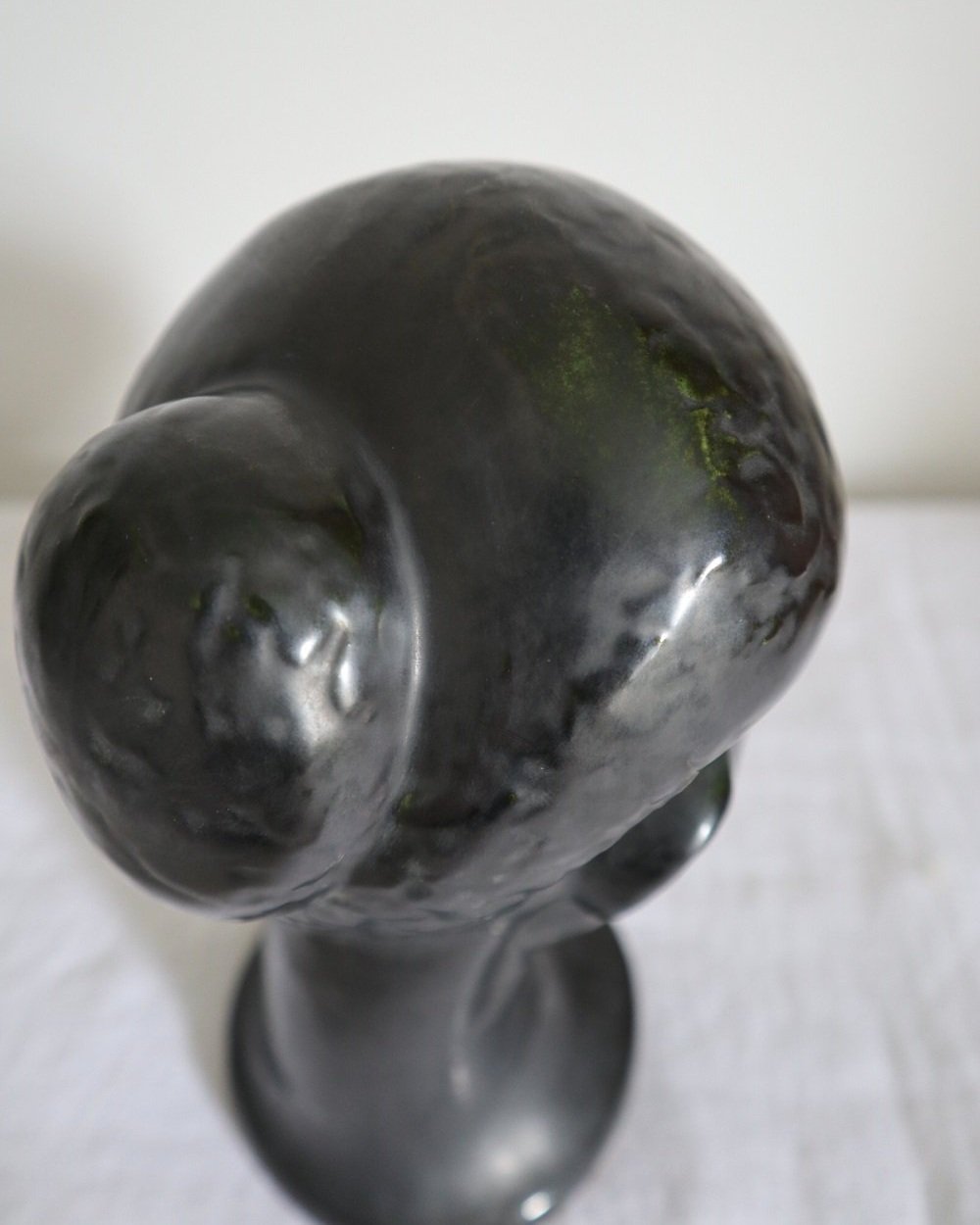 Rare mid century metallic black ceramic woman's head with eyes closed. Marked Dartmouth Devon England to base