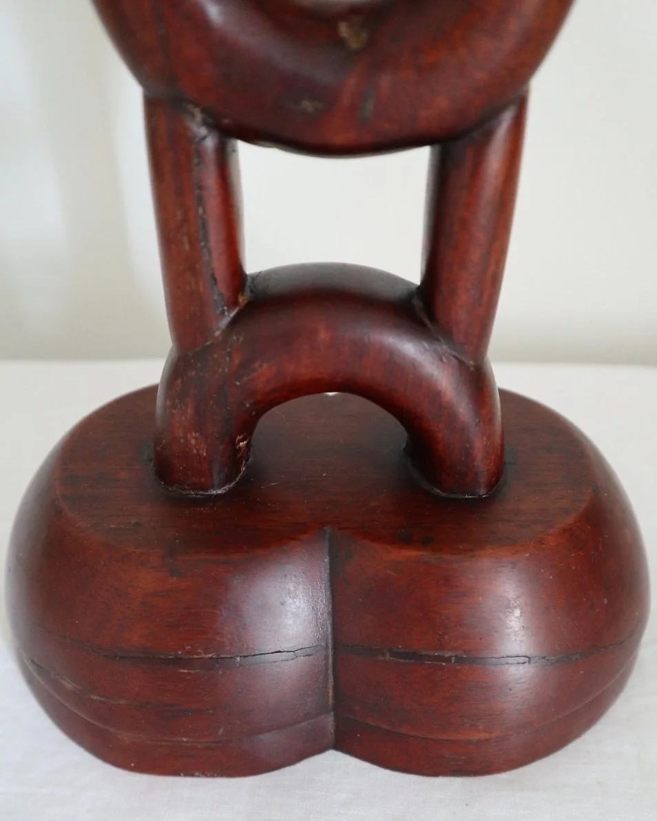 Tall mid century sculptural hand carved warm wooden totem table lamp with original hessian lampshade. Circa 1960s.