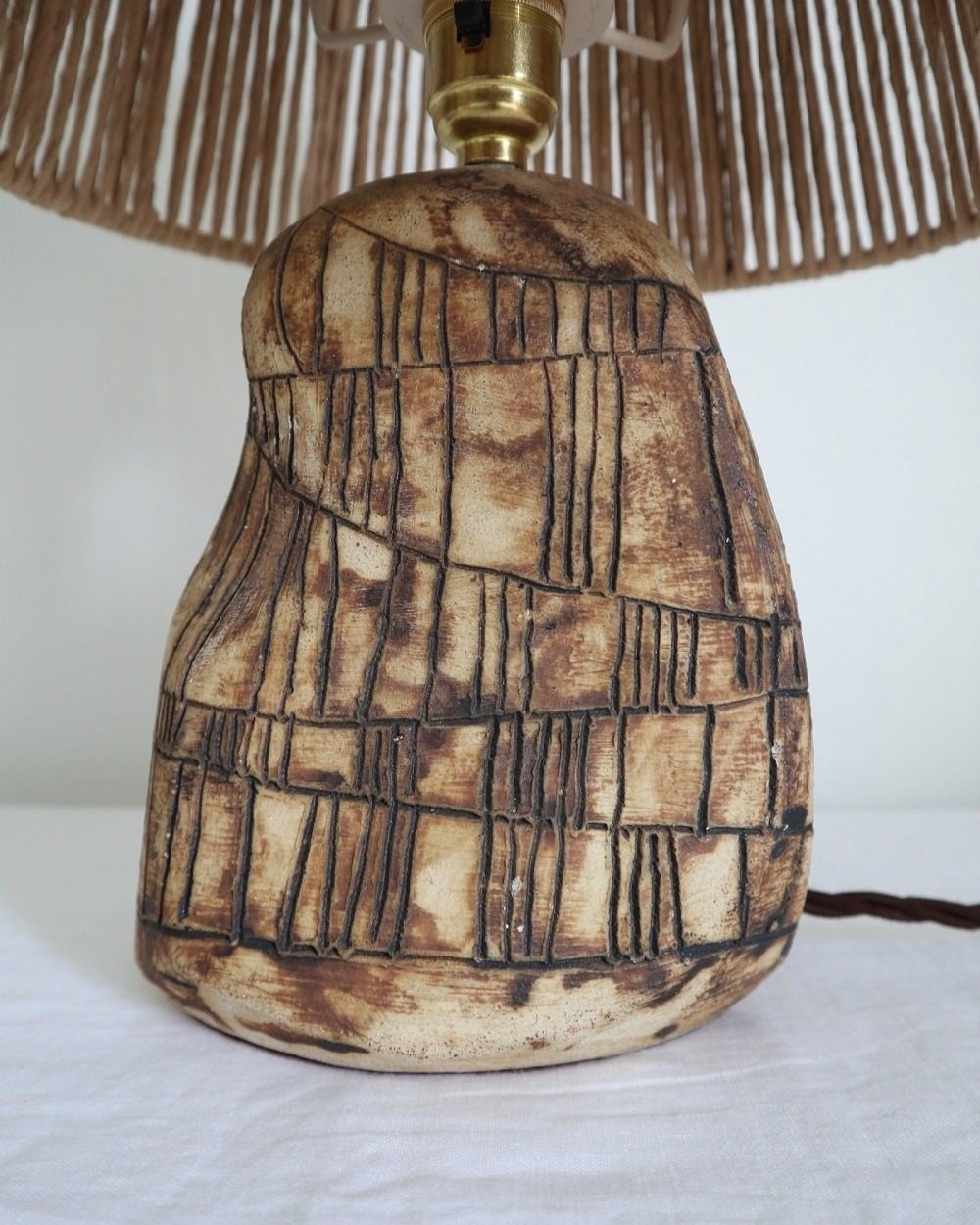 Organic shaped studio pottery table lamp with etched line decoration.