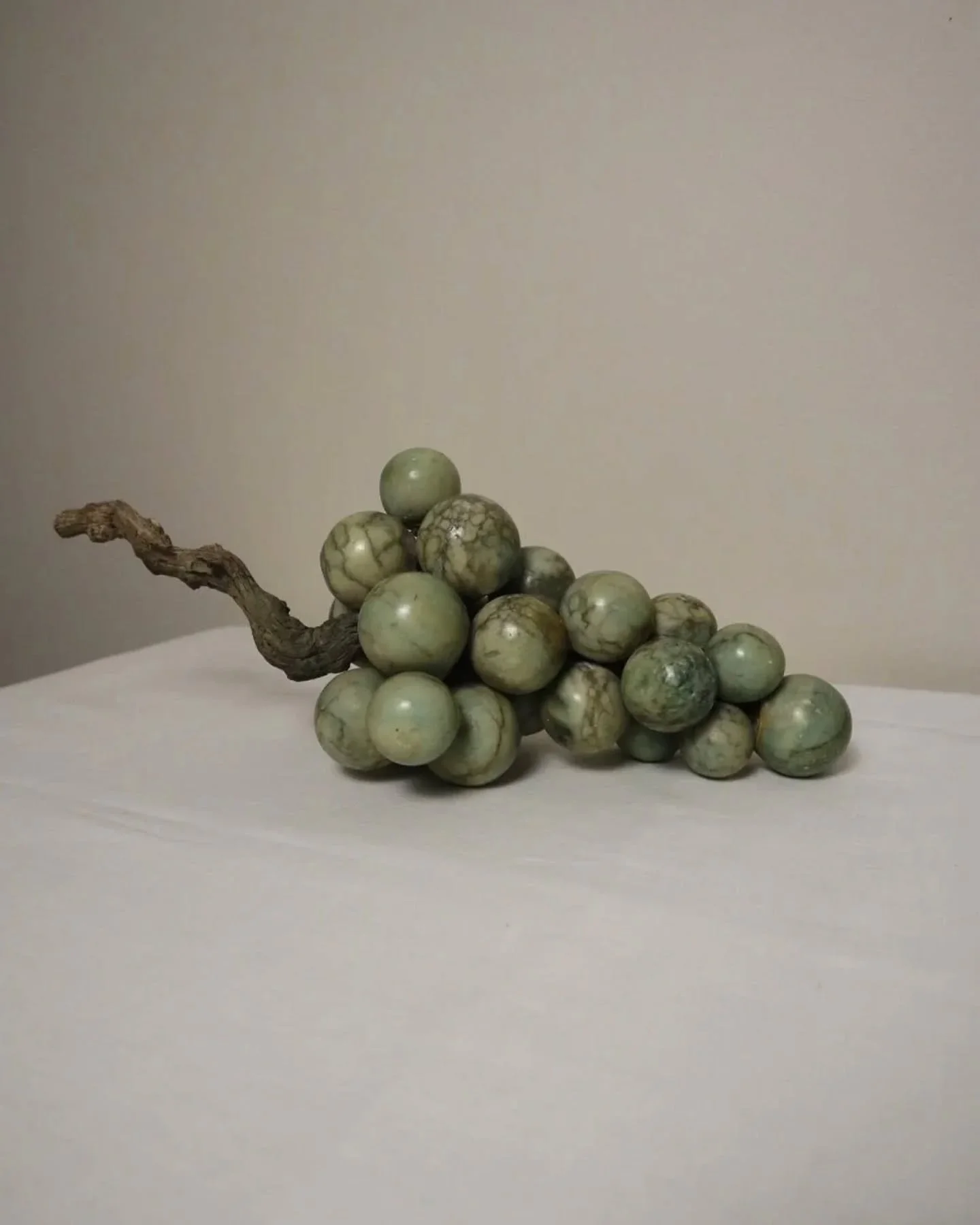 Available online ~ Large 1970s cluster of green alabaster grapes with real vine stem. 

Visible signs of wear consistent with age, scuffs, scratches, yellowing to the lacquer finish. Multiple areas where grapes have rubbed together and outer finish h