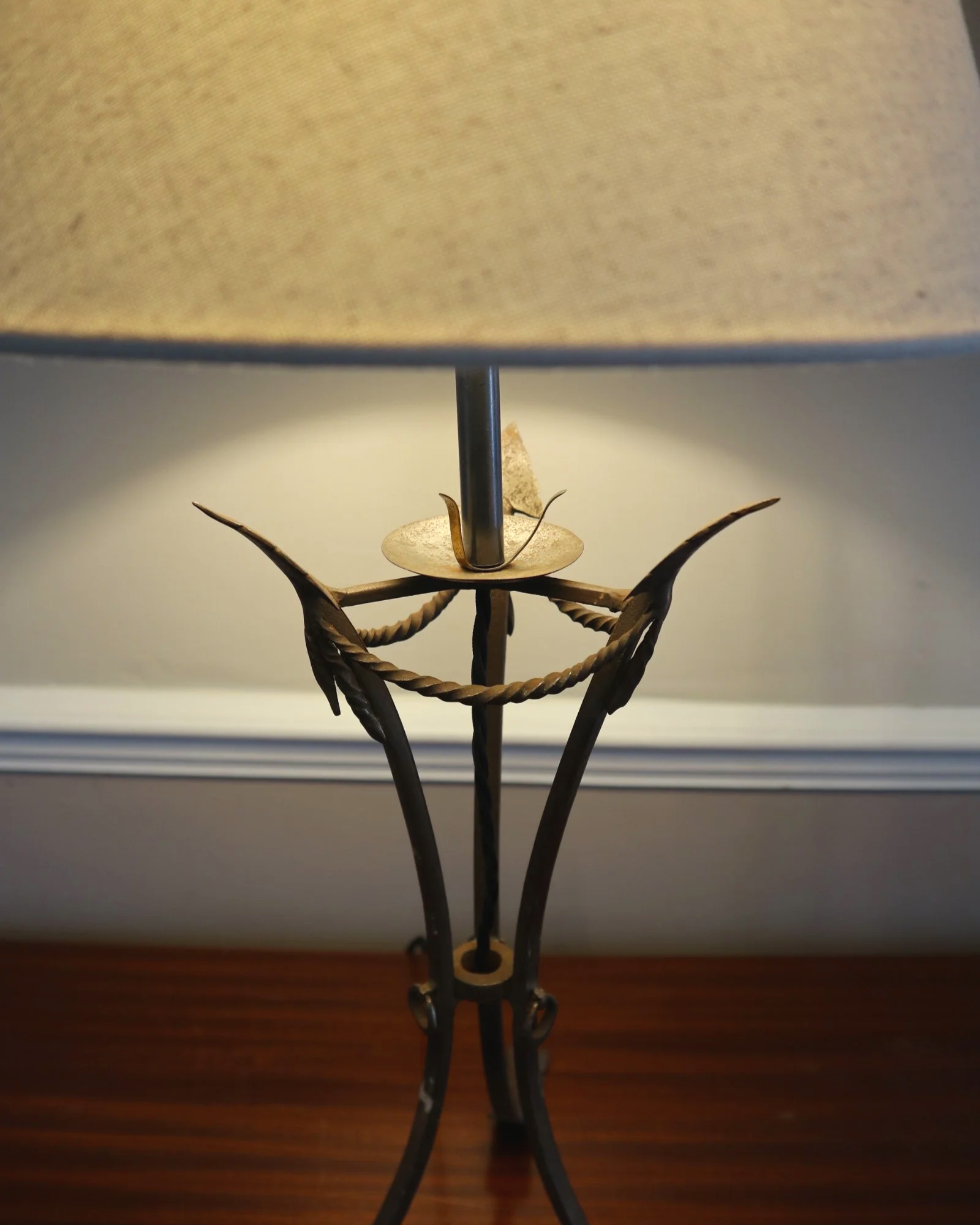Pair of French style mid century metal tripod table lamps featuring three arrows.