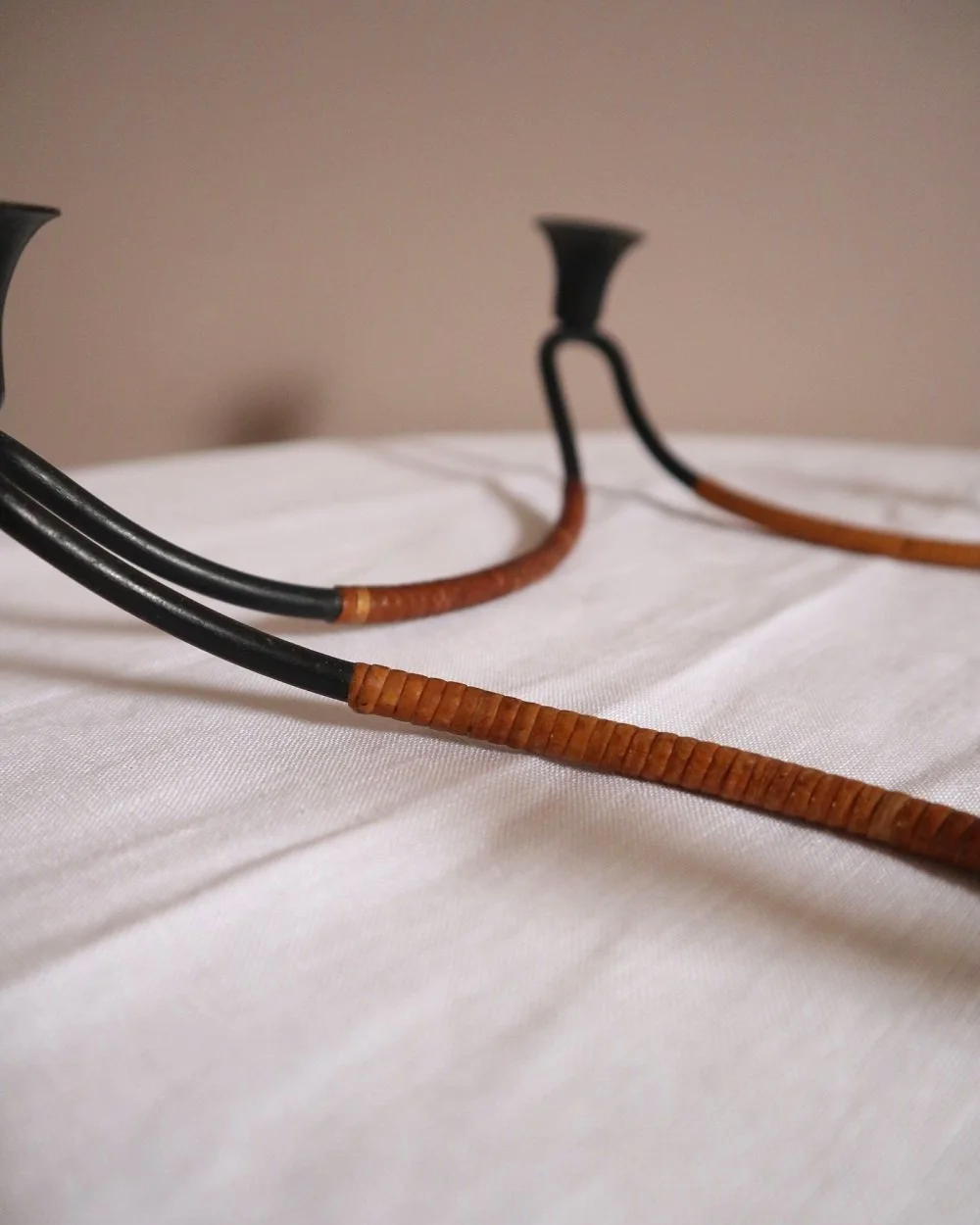 Modernist Danish iron and woven rattan four candle holder designed by Laurids Lønborg. Circa 1950s.