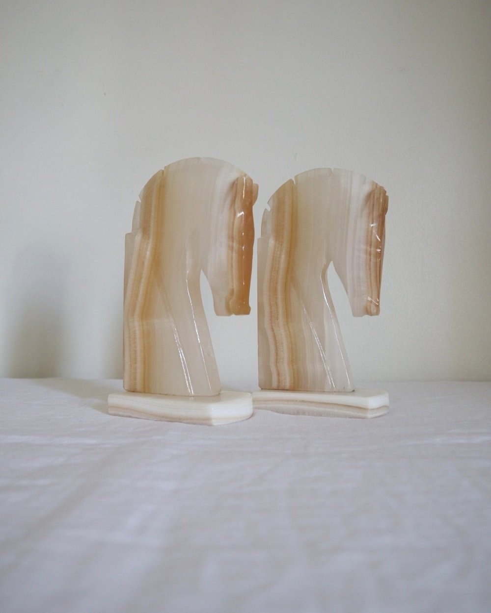pair of tall white onyx Trojan horse head bookends.