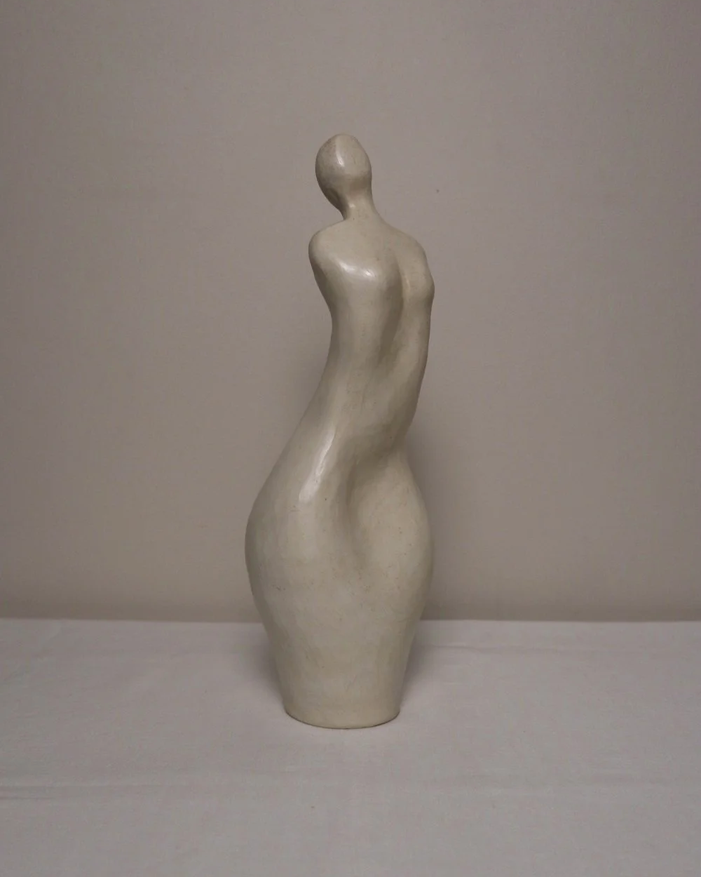 Set of three white ceramic abstract sculptures in the shape of the female form. Unknown age.  Signed 'R W Art / RoseWood Art'