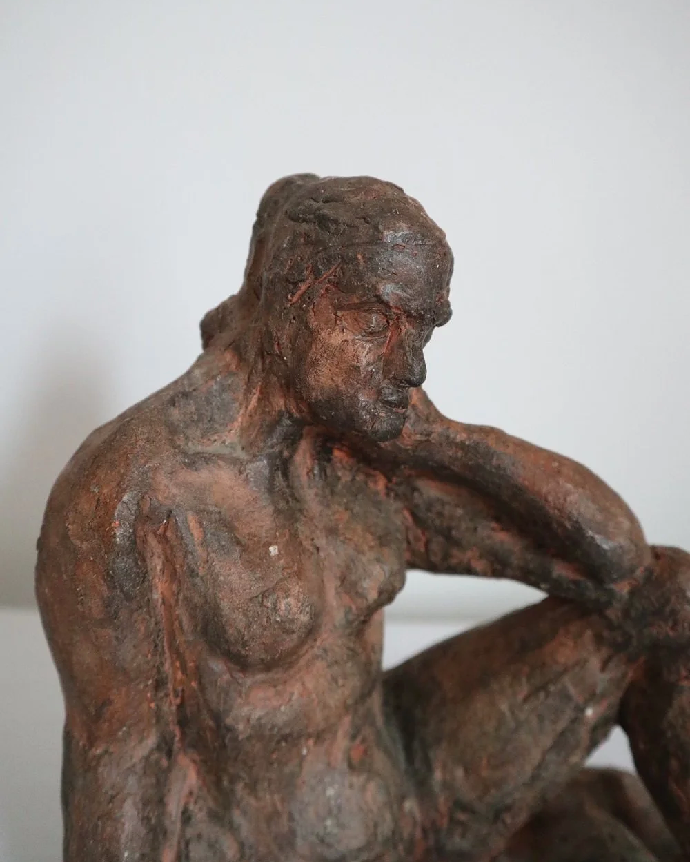 Heavy handmade studio pottery textured sculpture of seated nude woman.