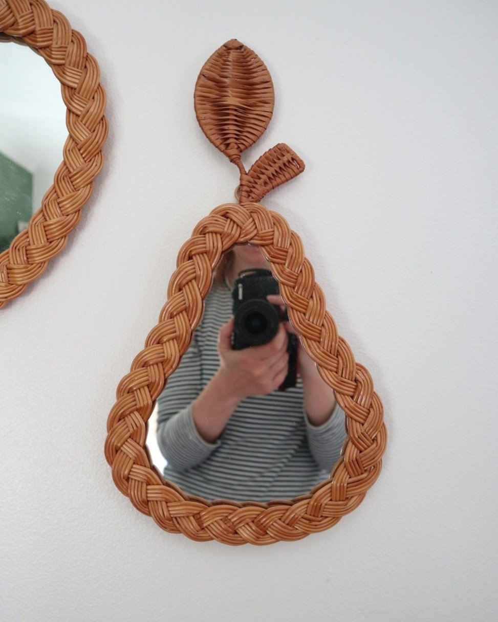 Pair of vintage small wall mirrors in the shape of an apple and a pear, with woven wicker frames.