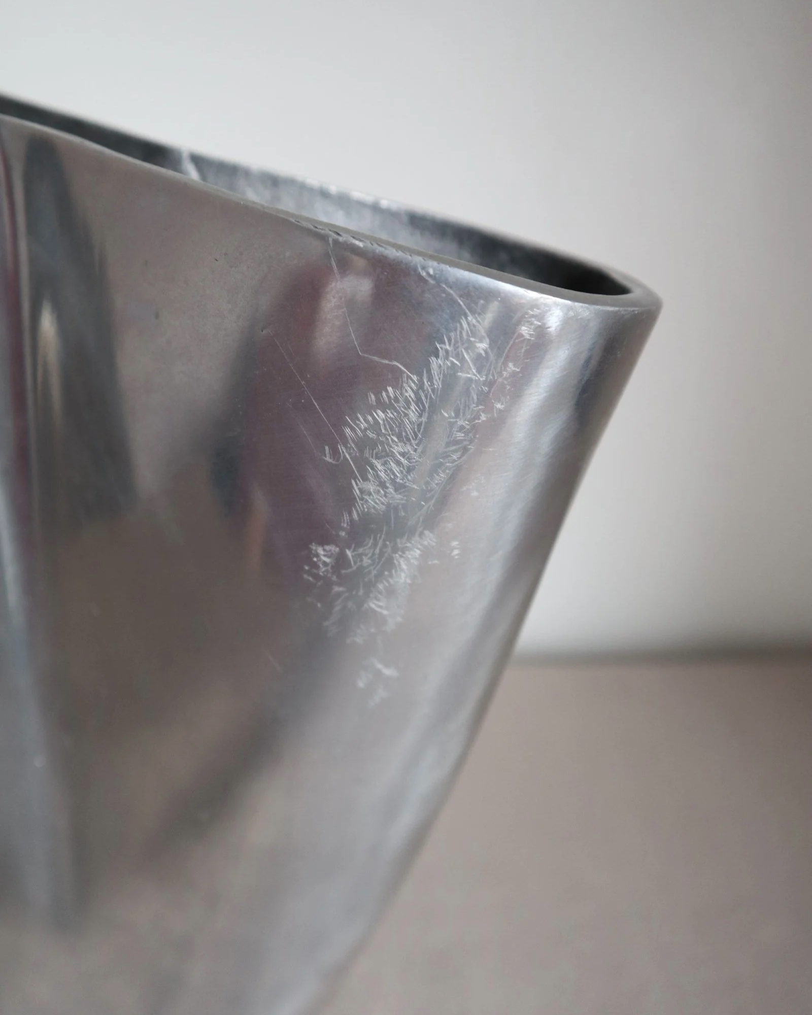 Postmodern heavy cast aluminium vase with sculptural form and four small inset stones. In the style of Anna Efverlund. Circa 1980s. Unsigned.