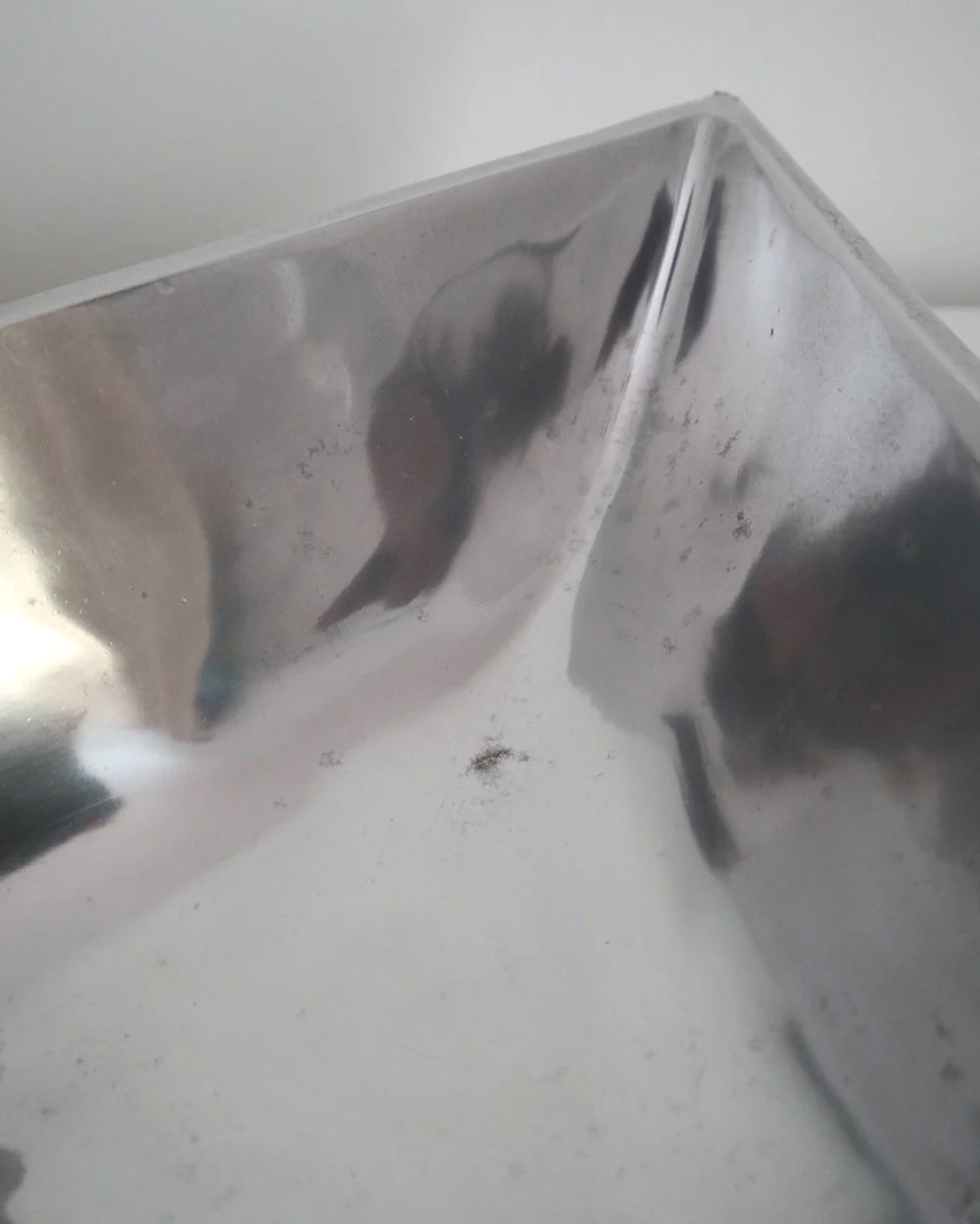 Solid shiny aluminium triangular Modernist style dish.