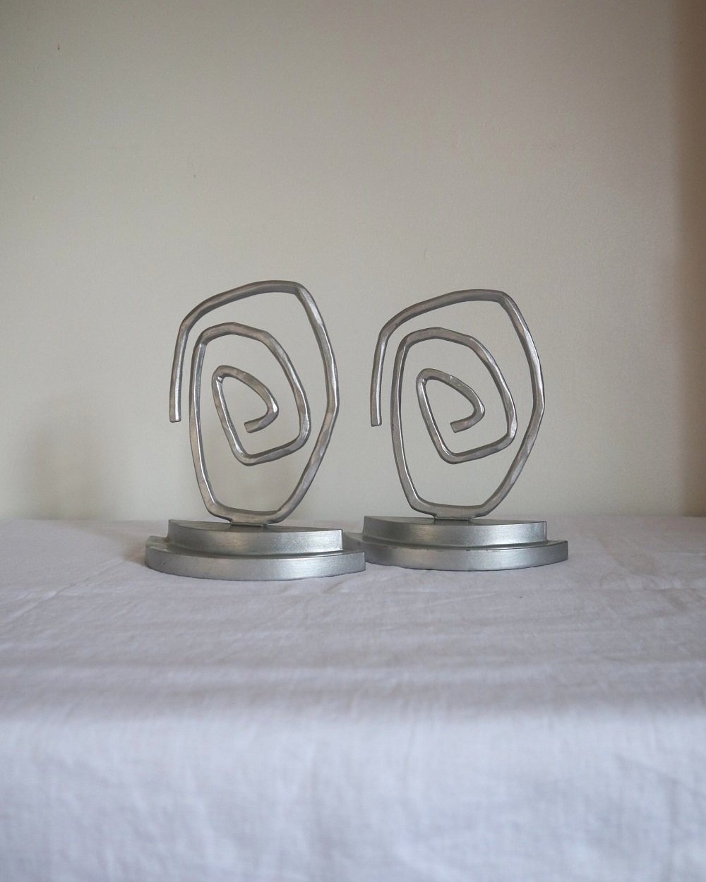 Pair of Postmodern sprayed silver spiral bookends, circa 1990s.