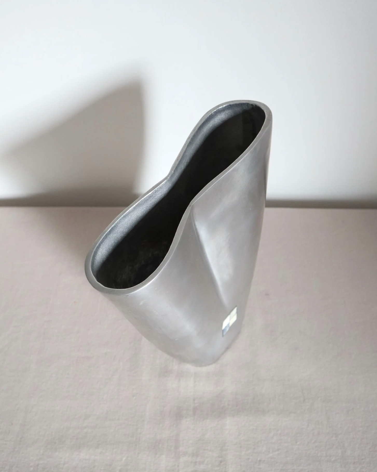 Postmodern heavy cast aluminium vase with sculptural form and four small inset stones. In the style of Anna Efverlund. Circa 1980s. Unsigned.