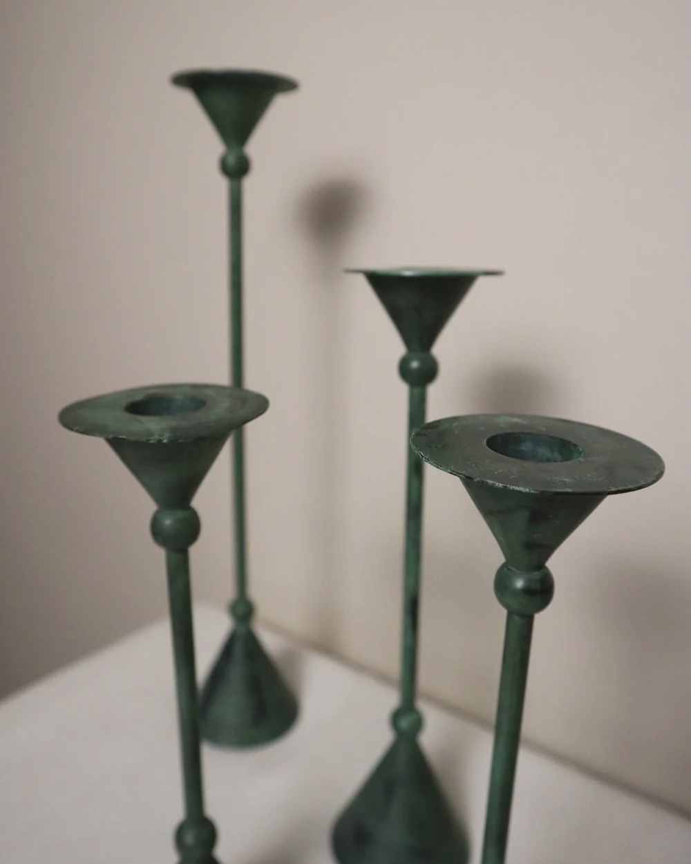 Set of 4 Postmodern verdigris metal candleholders, circa 1980s. In the Memphis style of Christian de Beaumont.