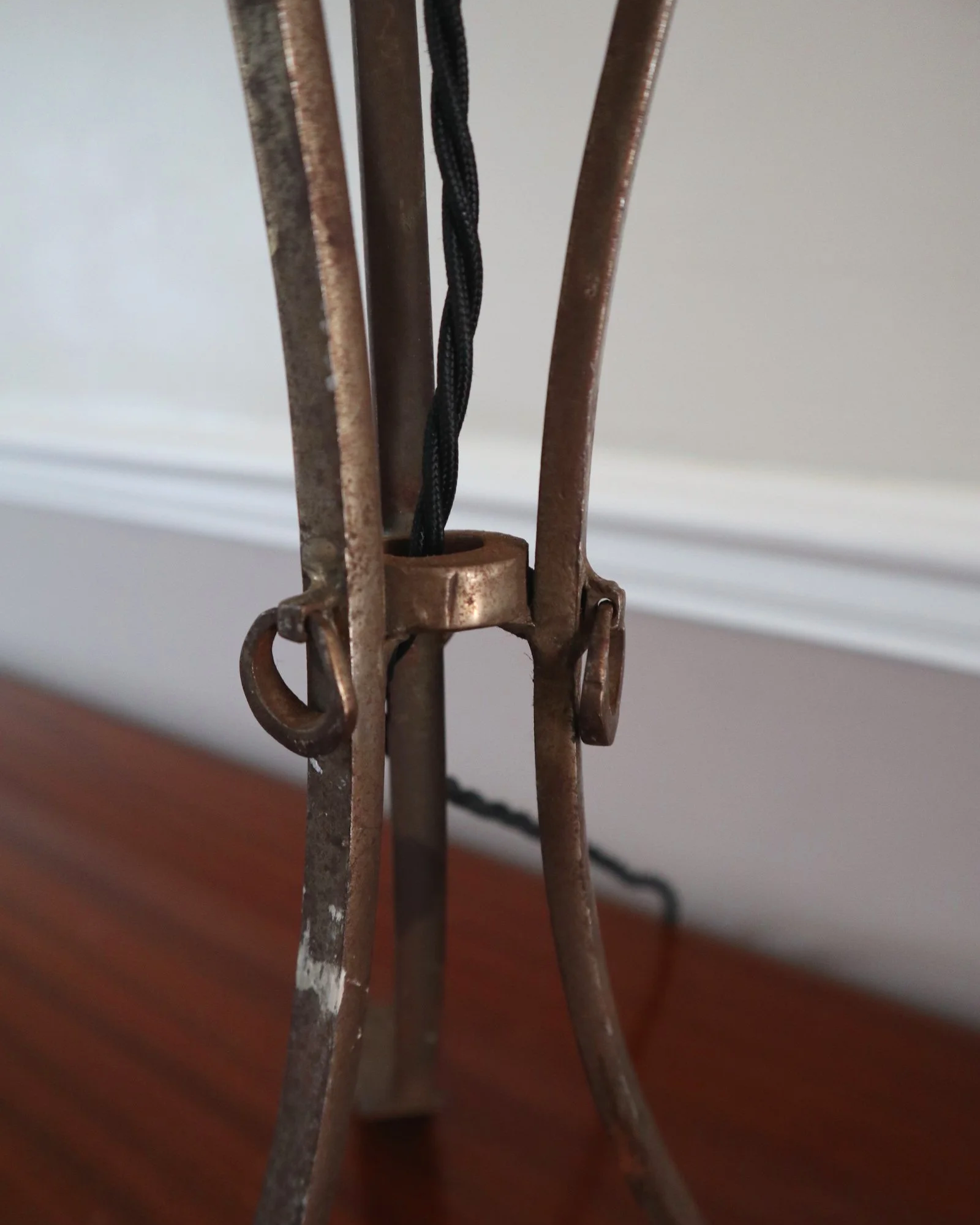 Pair of French style mid century metal tripod table lamps featuring three arrows.