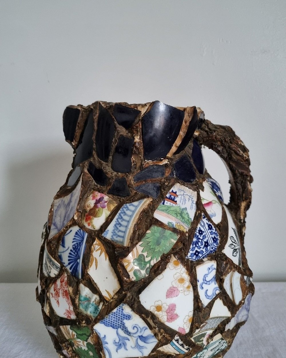 Large French pique assiette mosaic pottery jug with handle.