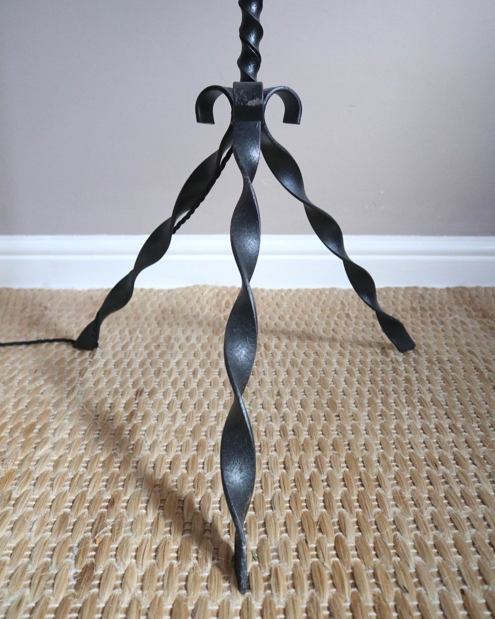 French wrought iron floor lamp with twisted corkscrew column and tripod base. Circa 1950s.