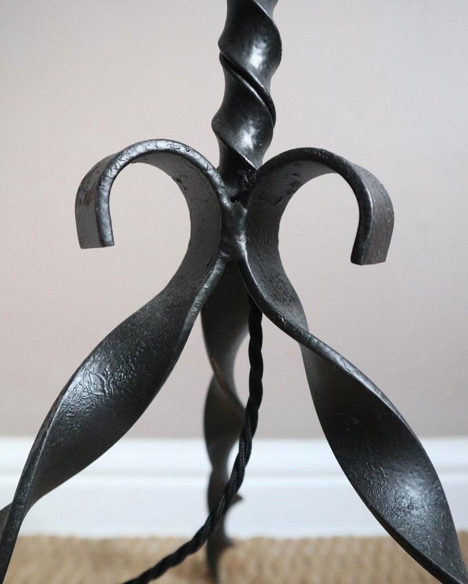 French wrought iron floor lamp with twisted corkscrew column and tripod base. Circa 1950s.