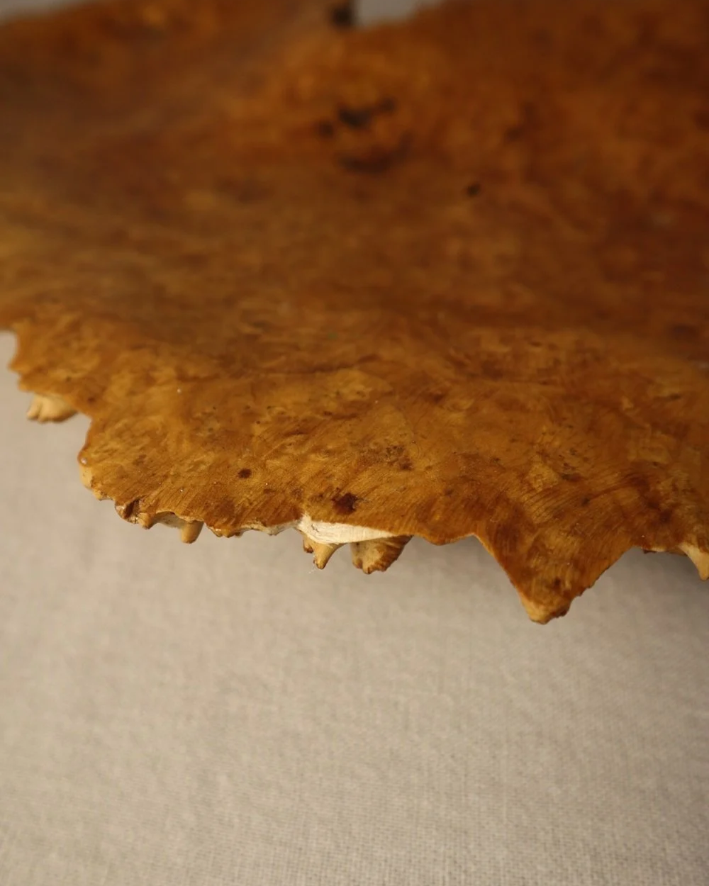 Decorative hand carved golden toned burr wood centrepiece dish with polished centre and organic naturalistic outside.