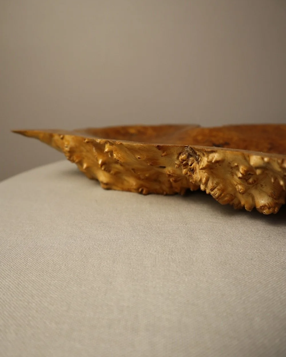 Decorative hand carved golden toned burr wood centrepiece dish with polished centre and organic naturalistic outside.
