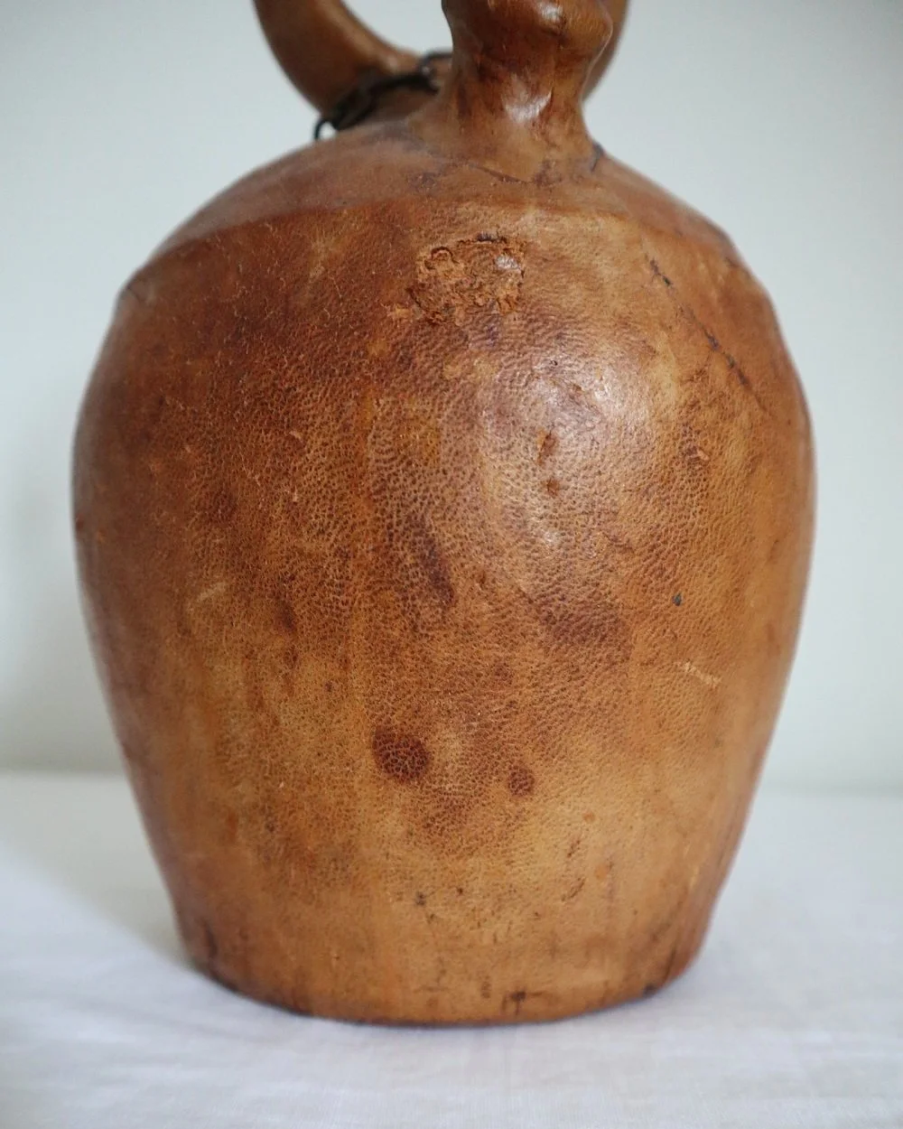 Spanish distressed tan leather covered oil or water pourer.