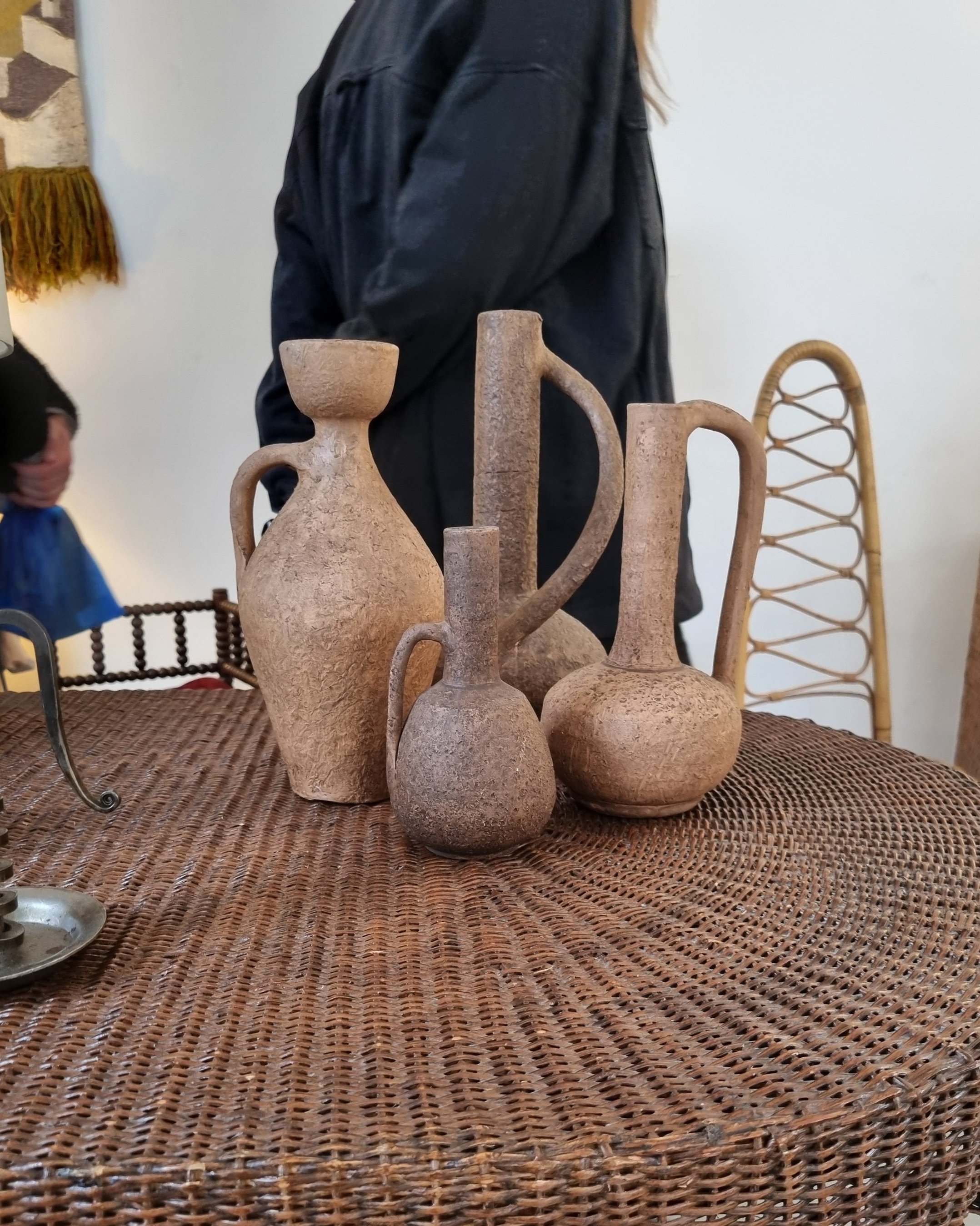 Set of four of mid century Brutalist sculptural textured brown ceramic vessels. Fragile terracotta with pock marked surface. Circa 1970s.
