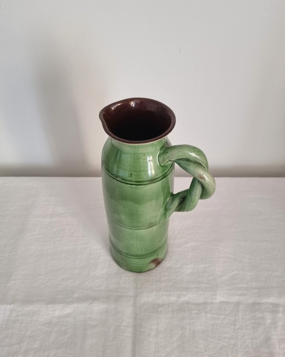 Tall studio pottery leaf green glazed water pitcher jug with twisted handle and banded centre. Marked Schofield Penrith.