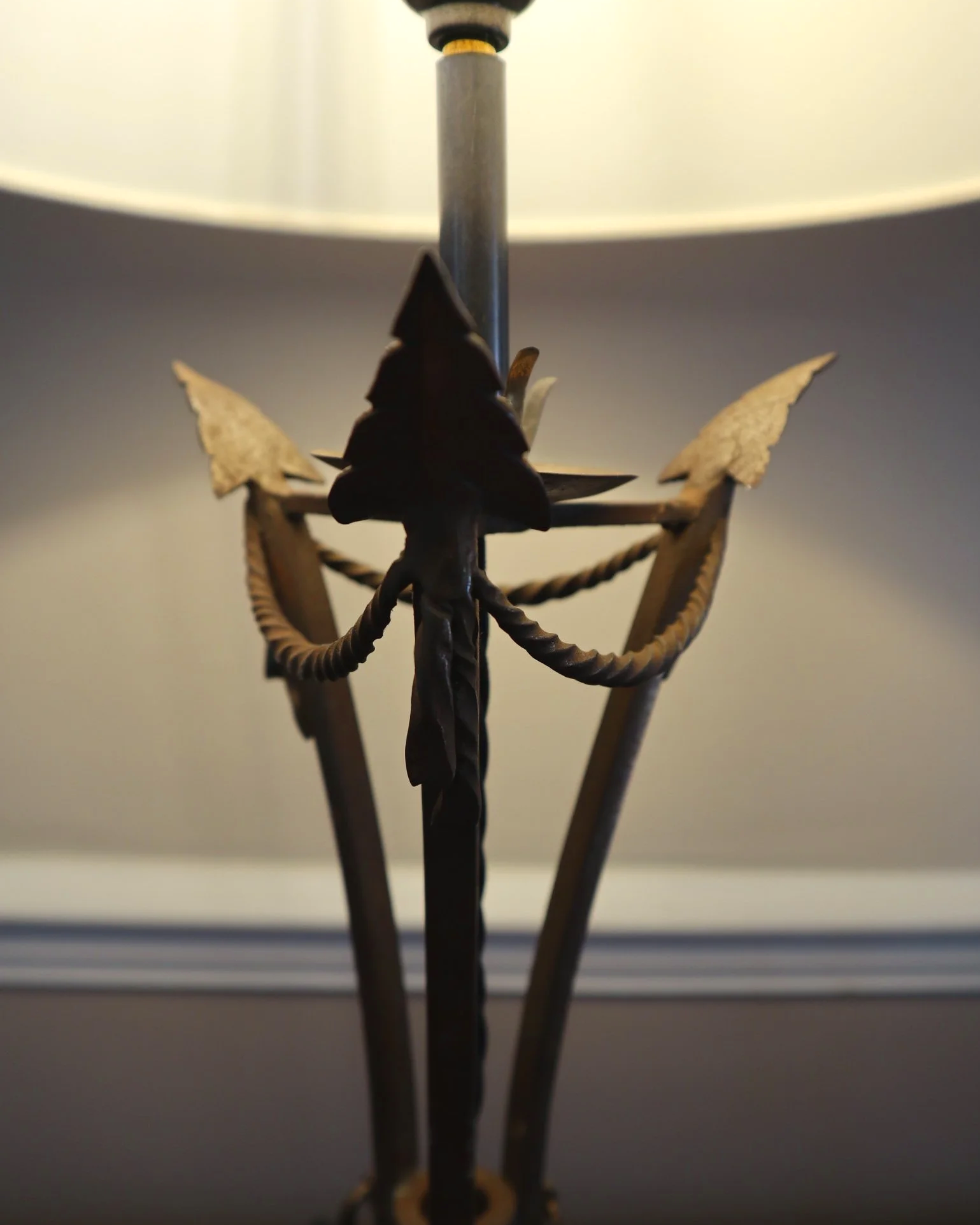 Pair of French style mid century metal tripod table lamps featuring three arrows.