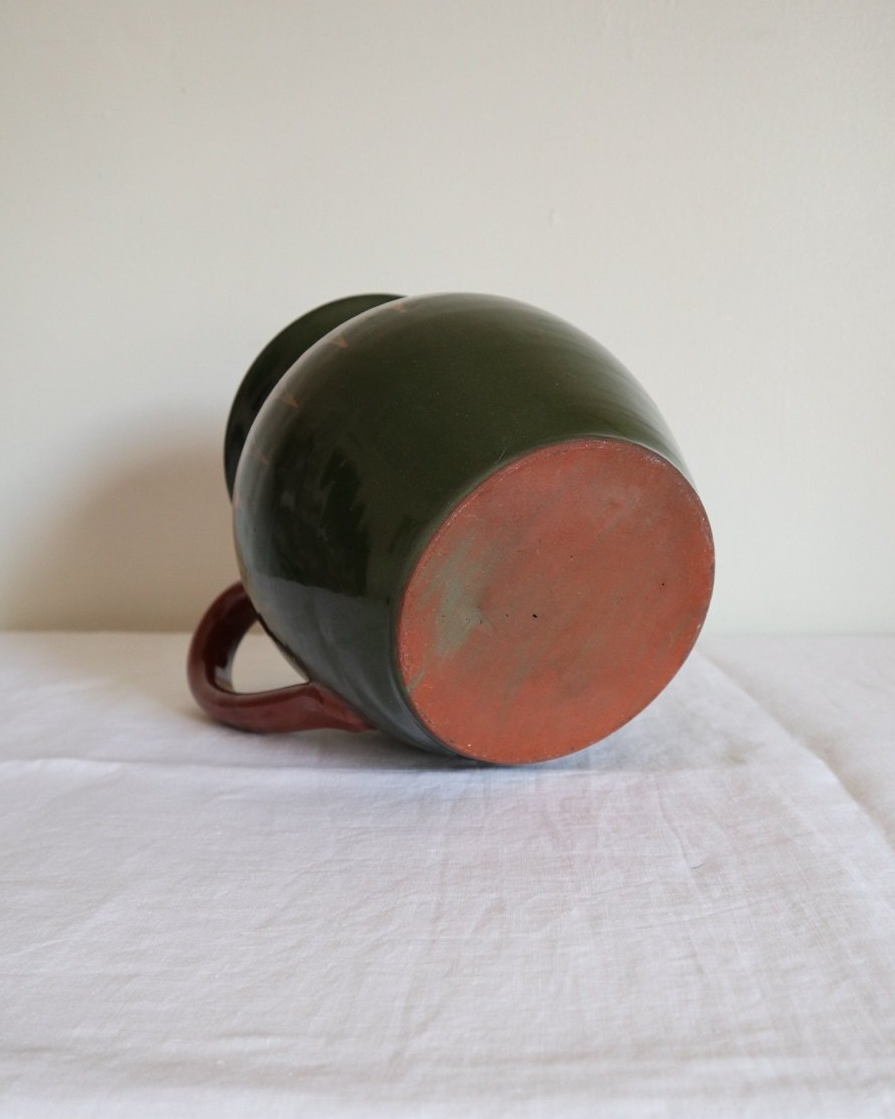 Large Bulgarian green and brown ceramic pitcher jug in traditional Troyan style.