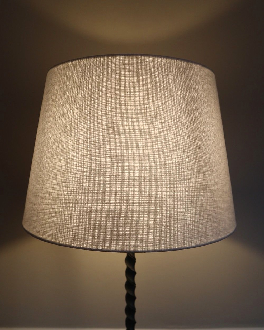French wrought iron floor lamp with twisted corkscrew column and tripod base. Circa 1950s.