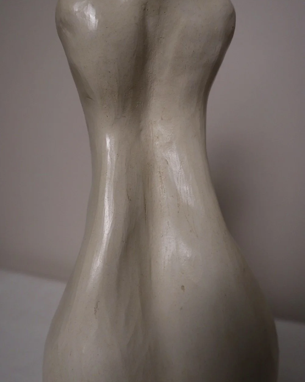 Set of three white ceramic abstract sculptures in the shape of the female form. Unknown age.  Signed 'R W Art / RoseWood Art'