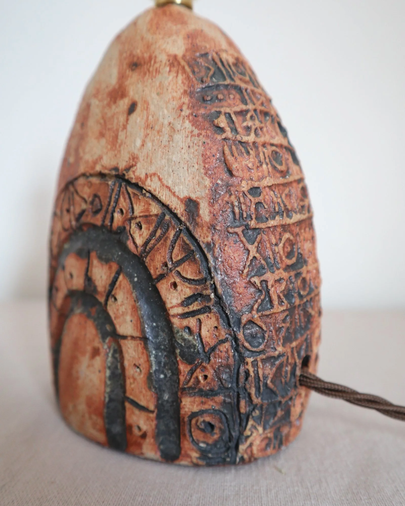 Small Brutalist stoneware table lamp by British potter Bernard Rooke. With stamped, rune-like impressions. Circa 1970s.