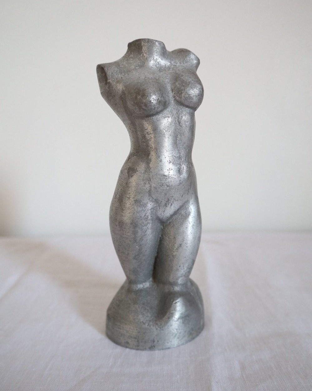 Modernist cast aluminium naked torso sculpture.