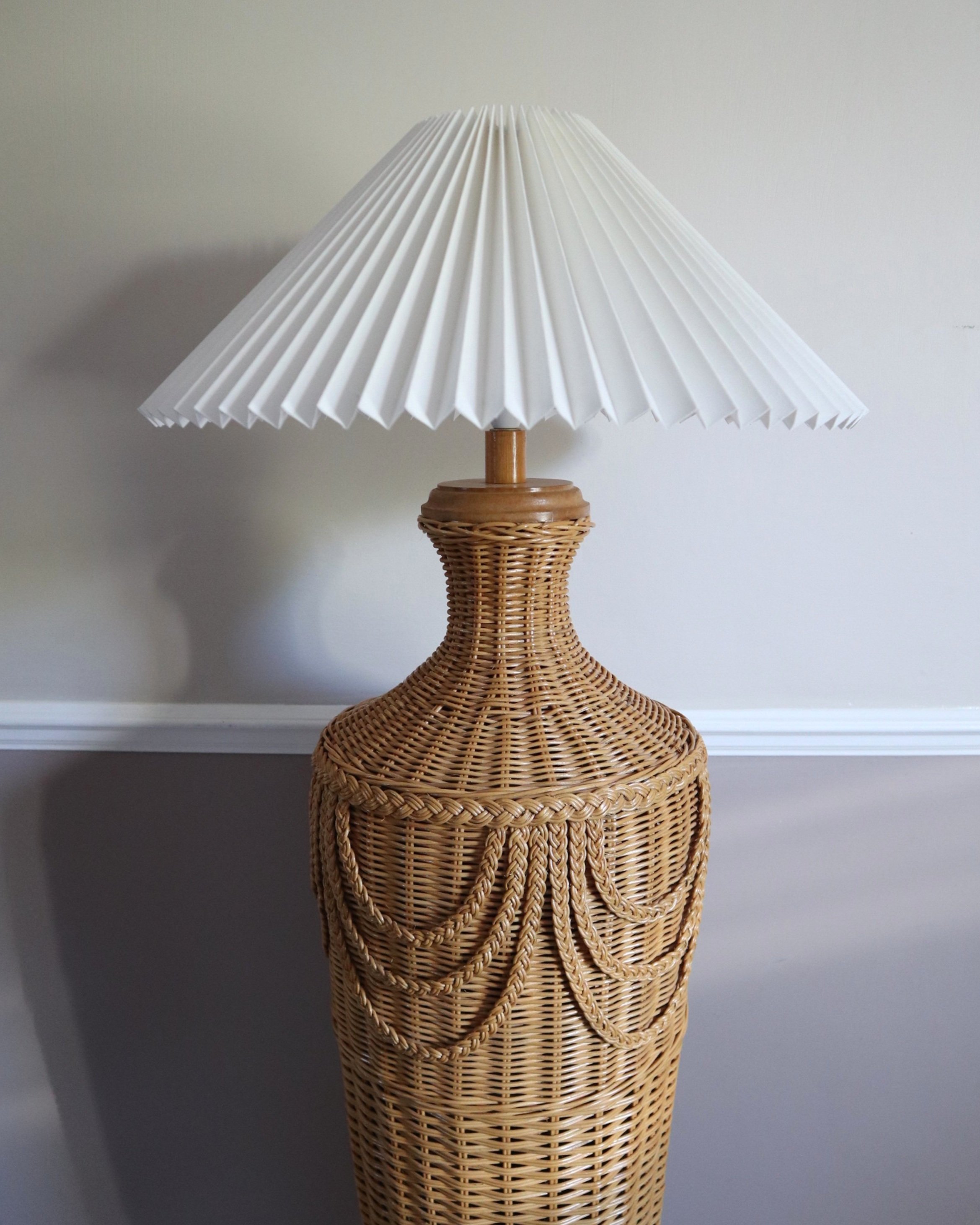 20th Century woven rattan floor lamp with Hollywood Regency style braided detailing.