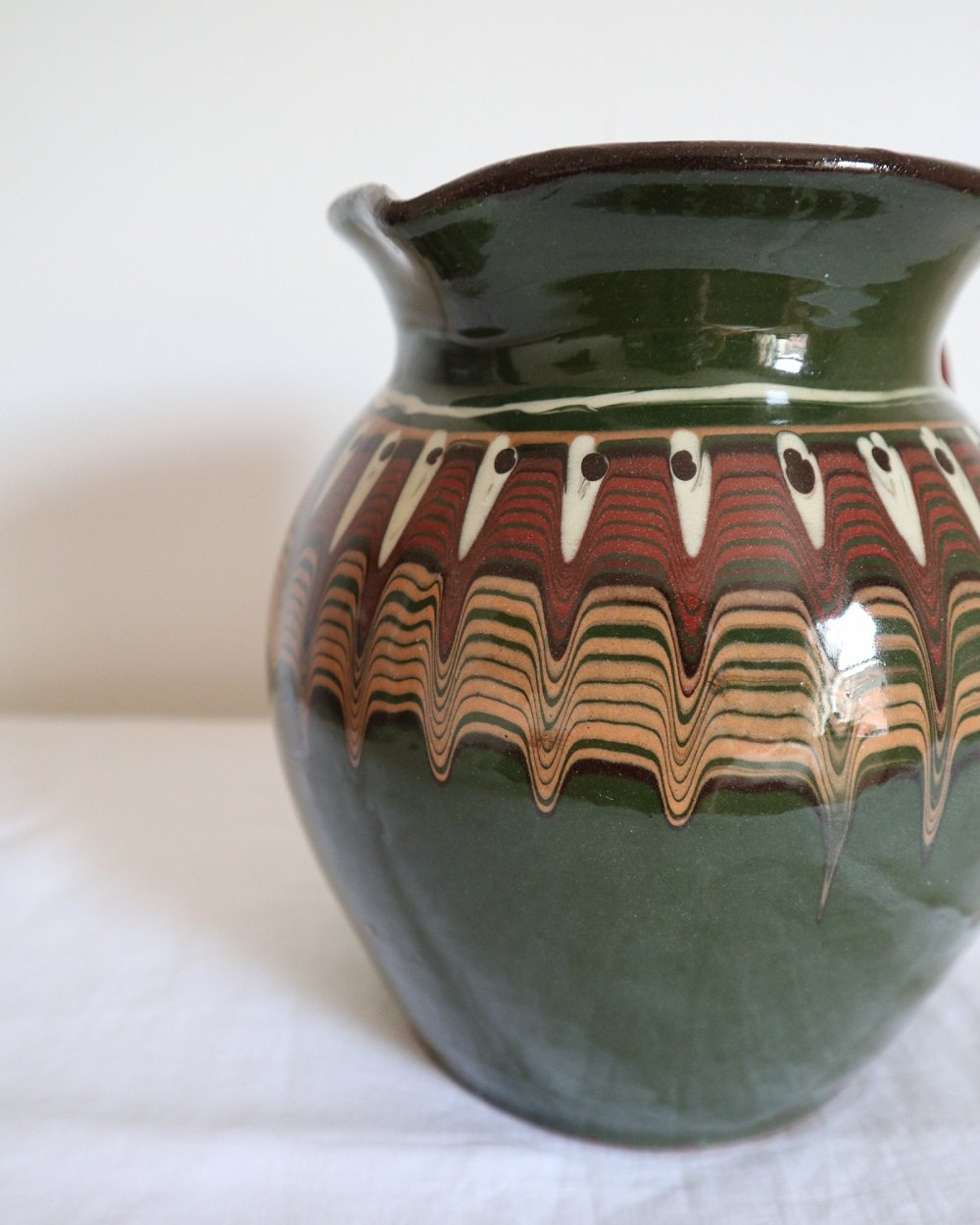 Large Bulgarian green and brown ceramic pitcher jug in traditional Troyan style.