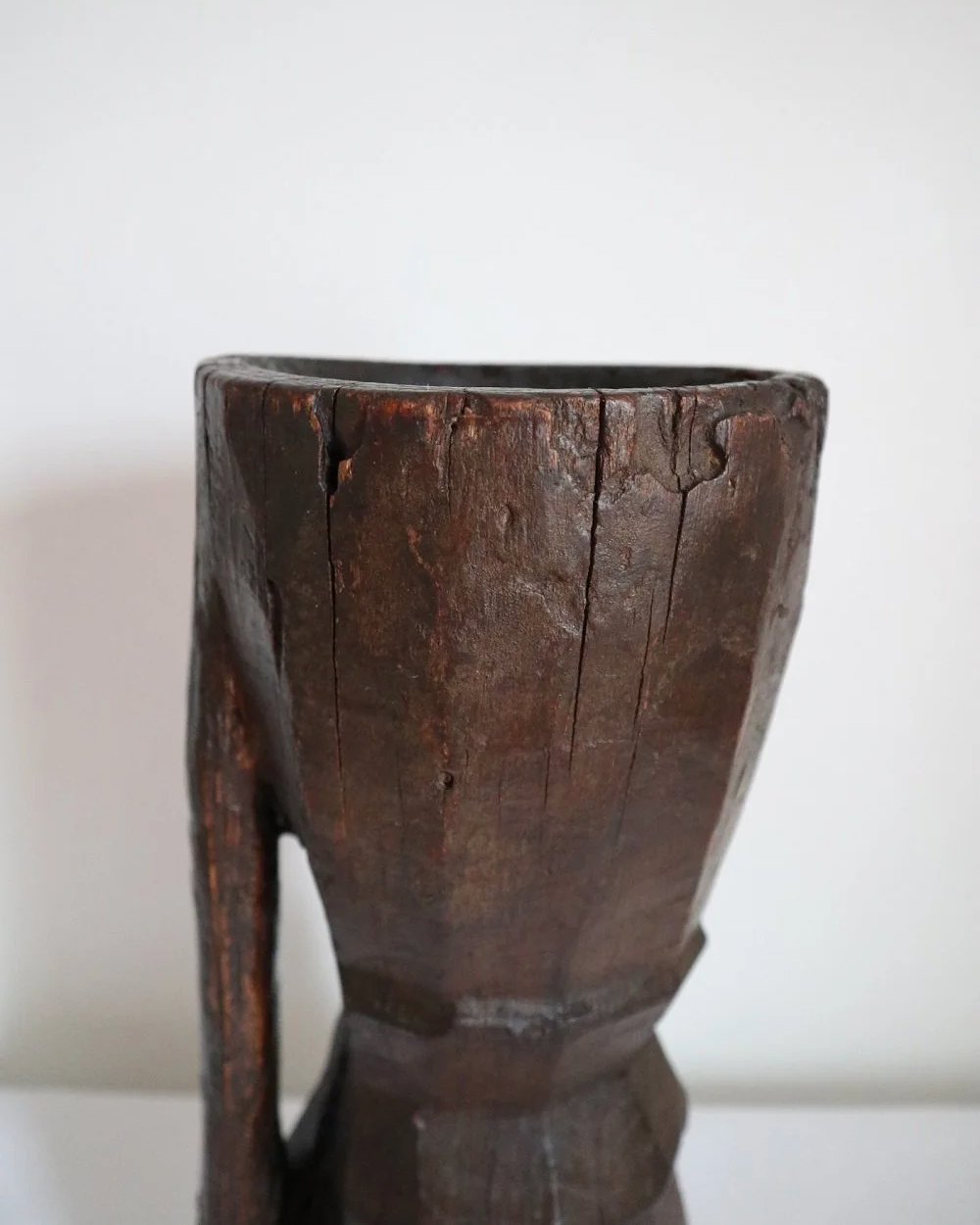 Heavy primitive sculptural carved wooden mortar with handle.