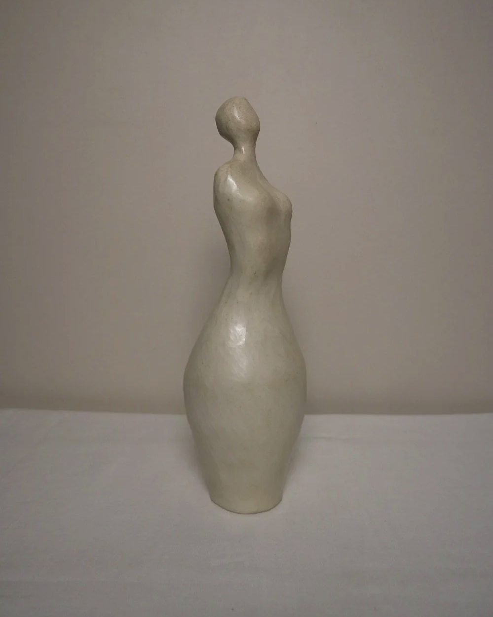 Set of three white ceramic abstract sculptures in the shape of the female form. Unknown age.  Signed 'R W Art / RoseWood Art'