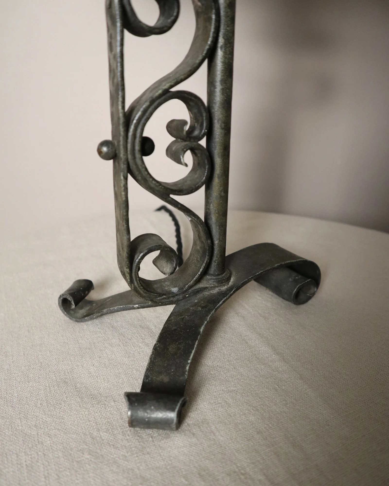Vintage Art Deco style metal candlestick table lamp with elegant scroll detailing.