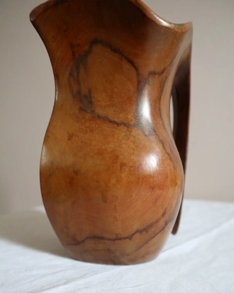 Small mid century hand carved sculptural olivewood jug in the style of Alexandre Noll. Circa 1960s.