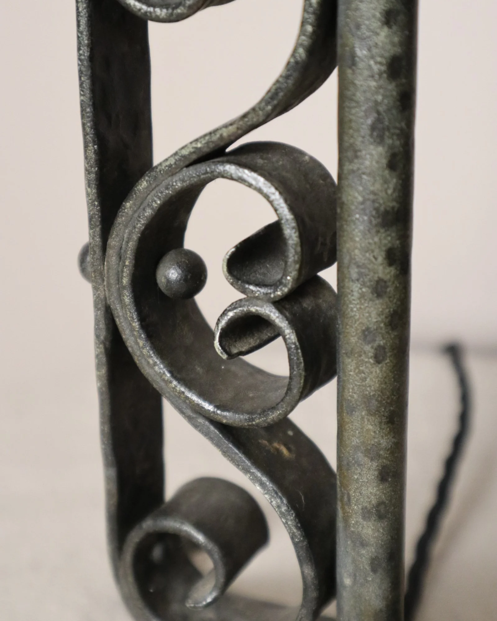Vintage Art Deco style metal candlestick table lamp with elegant scroll detailing.