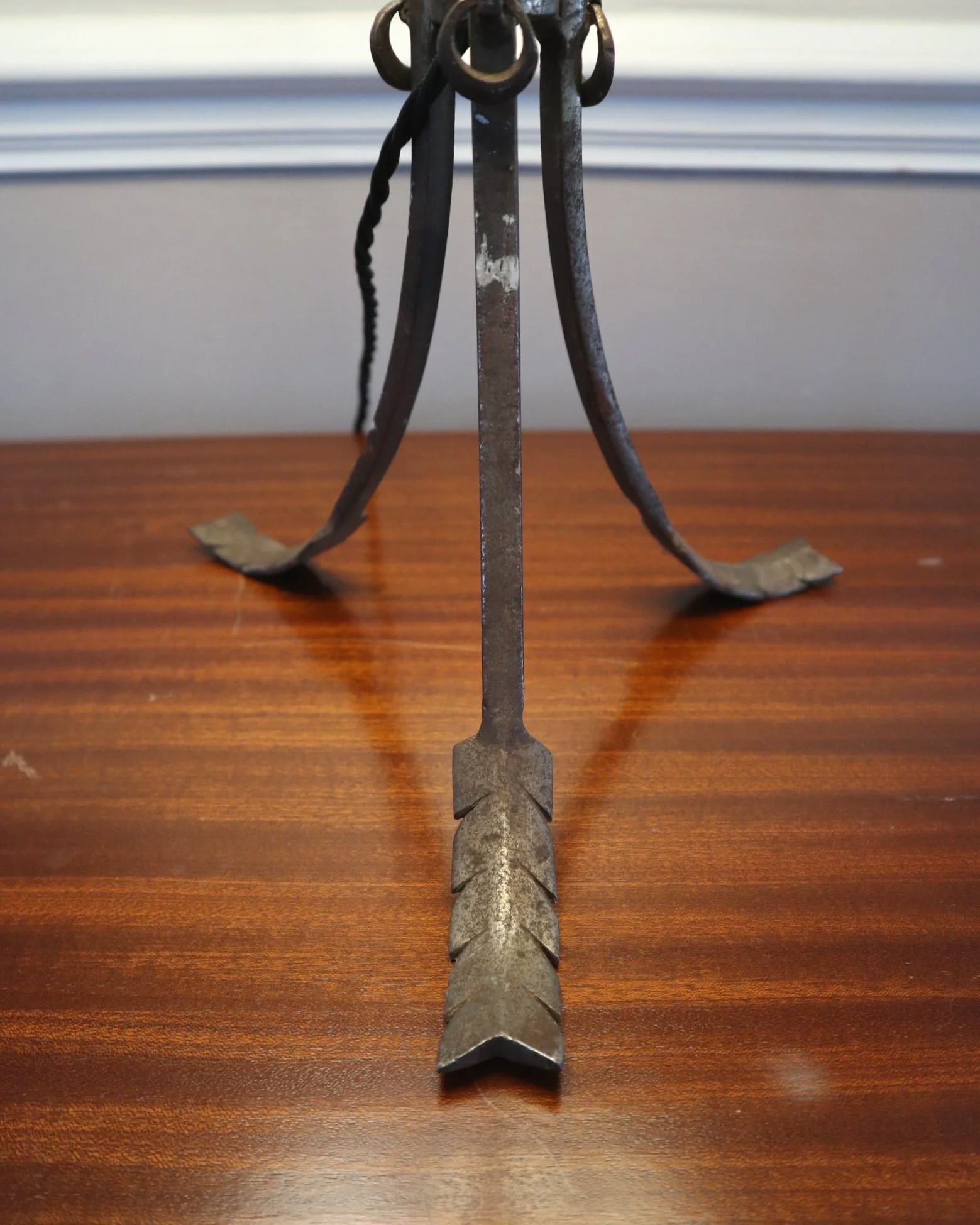 Pair of French style mid century metal tripod table lamps featuring three arrows.