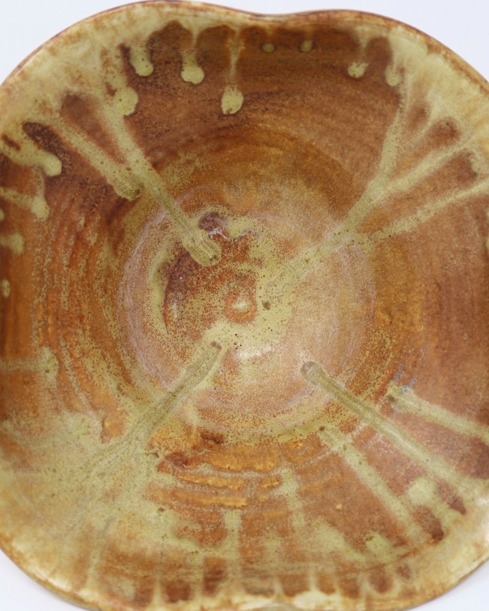 tage, handmade studio pottery ceramic bowl with wavy edge and brown, orange and ochre glaze. Marked Baughan 1997 to base.