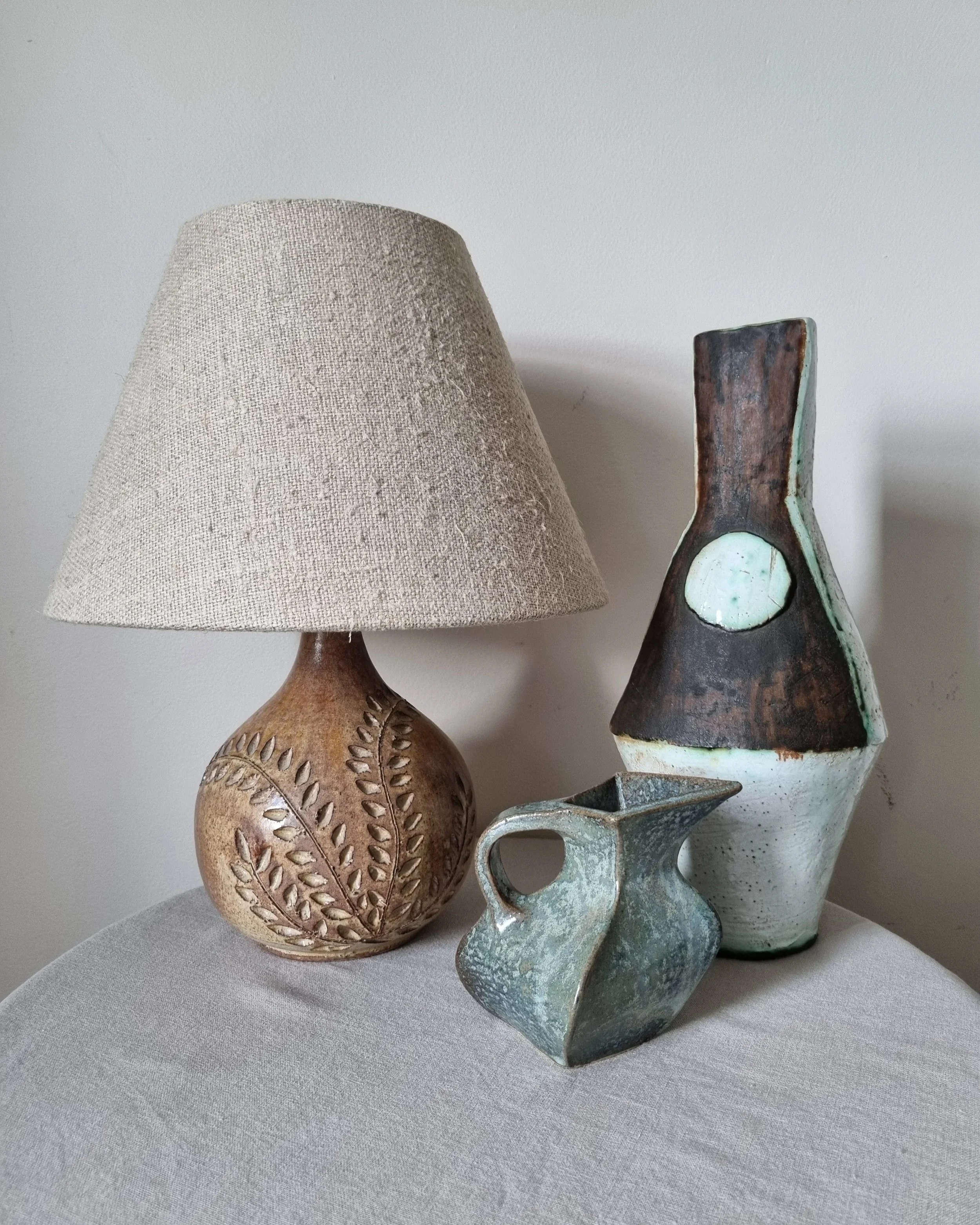 Vintage hand-built ceramic Brutalist art vase, featuring an abstract, asymmetrical design with textured white, dark brown, and subtle green glazes.